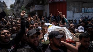 Mourners carry the bodies of Palestinians who were killed in Israeli airstrikes, during their funeral in Gaza City.