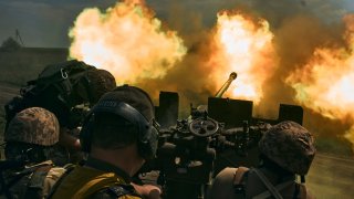 Ukrainian soldiers fire a cannon near Bakhmut, an eastern city where fierce battles against Russian forces have been taking place, in the Donetsk region, Ukraine, Monday, May 15, 2023.