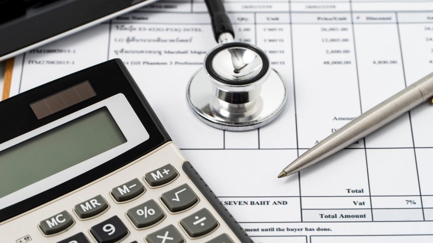 Stethoscope on medical billing statement on table, all text is anonymous