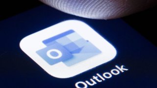 The logo of the software Microsoft Outlook is shown on the display of a smartphone. — Thomas Trutschel/Photothek