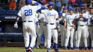 HOOVER, AL – MAY 25: Florida Gators catcher Luke Heyman (28) greets his teammates after hitting a home run during the 2023 SEC Baseball Tournament game between the Vanderbilt Commodores and the Florida Gators on May 25, 2023 at Hoover Metropolitan Stadium in Hoover, Alabama.  (Photo by Michael Wade/Icon Sportswire via Getty Images)