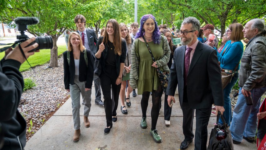 Youth plaintiffs are greeted by supporters as they arrive for the nation’s first youth climate change trial at Montana’s First Judicial District Court on June 12, 2023 in Helena, Montana. Sixteen plaintiffs, ranging in age from 6 to 22, are suing the state for promoting fossil fuel energy policies that they say violate their constitutional right to a “clean and healthful environment”.