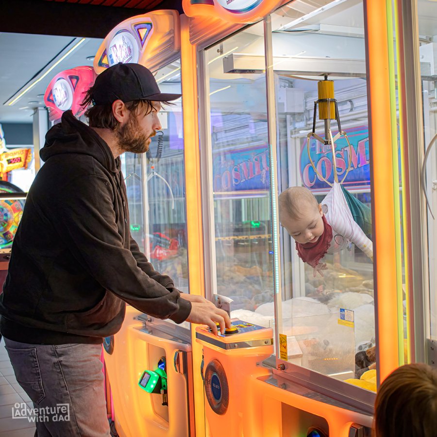A photoshopped image of Kenny Deuss fishing Aster out of a claw machine game.