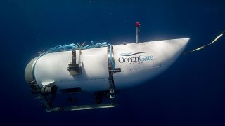 FILE - An undated photo shows a tourist submersible belonging to OceanGate beginning a descent at sea.