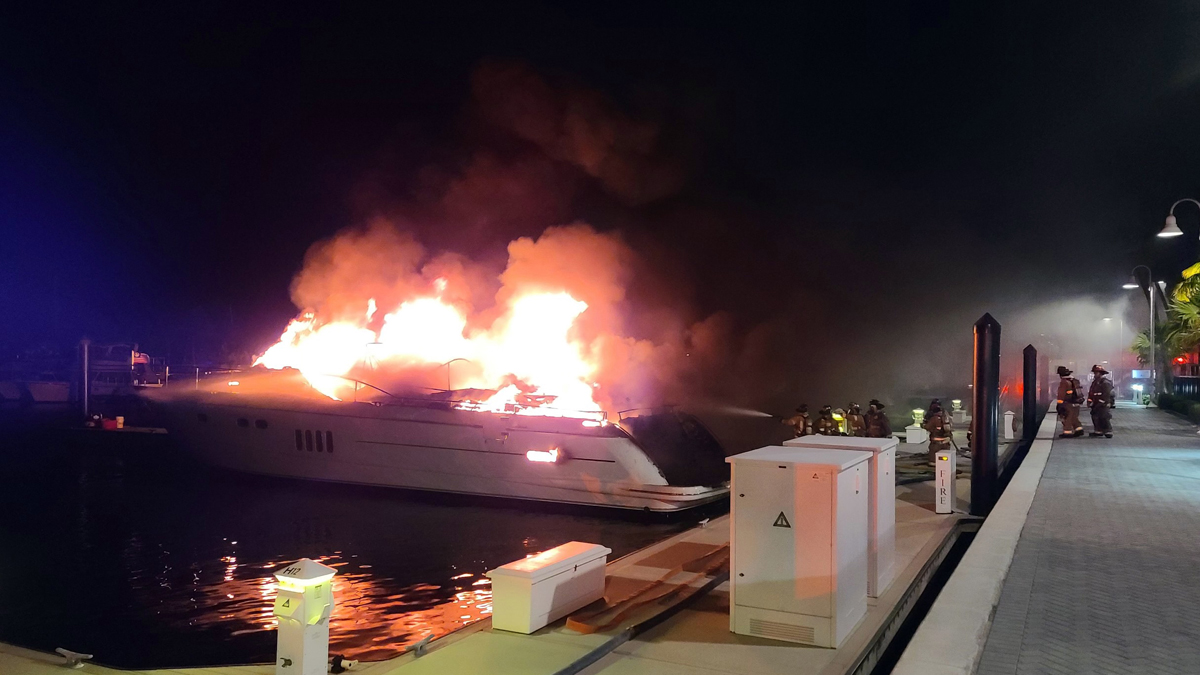Two men were hospitalized and a woman was missing after the large yacht they were on went up in flames in the Florida Keys.