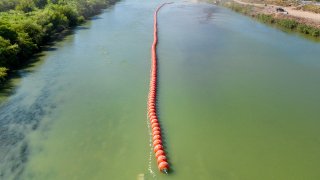 EAGLE PASS, TEXAS – JULY 18: Buoy barriers are installed and situated in the middle of the Rio Grande river on July 18, 2023 in Eagle Pass, Texas. Texas has begun installing buoy barriers along portions of the Rio Grande river in an effort to deter illegal border crossings.