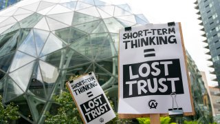 Amazon workers hold signs during a walkout event at the company’s headquarters on May 31, 2023 in Seattle, Washington.