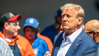 Former President Donald Trump speaks with the press at the Iowa Pork Producers booth during the 2023 Iowa State Fair in Des Moines, Iowa, Aug. 12, 2023.