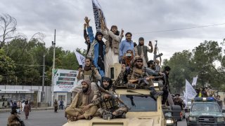 File - Taliban fighters celebrate one year since they seized the Afghan capital, Kabul, in front of the U.S. Embassy in Kabul