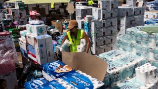 Volunteers load water onto a boat to be transported to West Maui from the Kihei boat landing on Aug. 13, 2023, in Kihei, Hawaii.