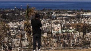 A person records the aftermath of a wildfire in Lahaina, Hawaii, Saturday, Aug. 19, 2023.