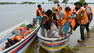 Rescue workers evacuate villagers through a boat from a flooded area of Pakpattan district of Pakistan’s Punjab province, Wednesday, Aug. 23, 2023. Rescuers have evacuated more than 100,000 people from flood-hit areas of Pakistan’s eastern Punjab province in the past three weeks, officials said Wednesday.