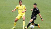 NASHVILLE, TN - MAY 02: Nashville SC defender Daniel Lovitz (2) and Inter Miami midfielder Lewis Morgan (7) chase a loose ball during a match between Nashville SC and Inter Miami, May 2, 2021, at Nissan Stadium in Nashville, Tennessee. (Photo by Matthew Maxey/Icon Sportswire via Getty Images)