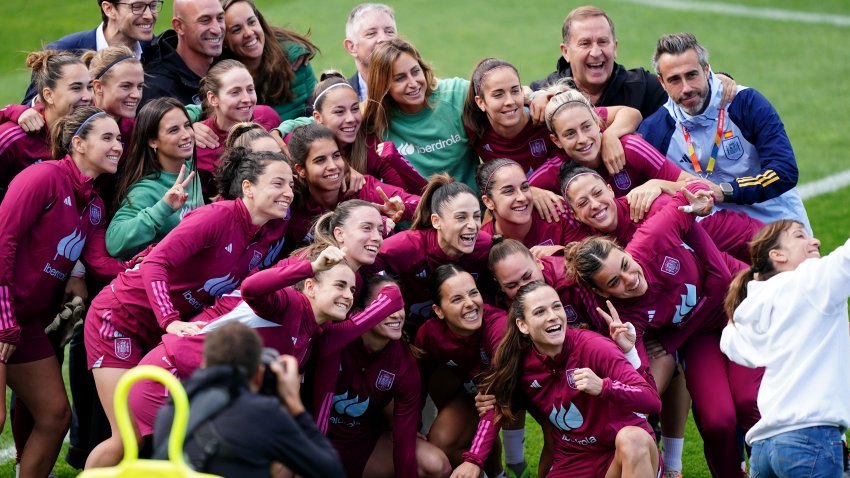 Spain's women's soccer team smiling at camera