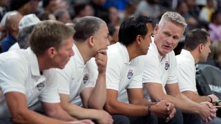 United States head coach Steve Kerr, fourth from left, speaks with assistant coach Erik Spoelstra, third from left, during the first half of an exhibition basketball game against Puerto Rico, Monday, Aug. 7, 2023, in Las Vegas.