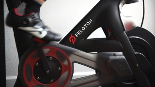 Cari Gundee rides her Peloton exercise bike at her home in San Anselmo, California, April 6, 2020.