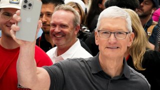 Apple CEO Tim Cook holds a new iPhone 15 Pro during the ‘Wonderlust’ event at the company’s headquarters in Cupertino, California, U.S. September 12, 2023. 