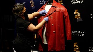 Collections assistant Cyrene Cruz primps a red leather jacket that was worn by the late rapper The Notorious B.I.G.