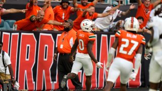 Fans react after Miami wide receiver Brashard Smith (0) scores