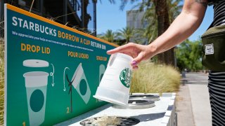 A reusable cup is returned to a borrow a cup return bin at an Arizona State University Starbucks shop