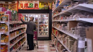 FILE - A man shops in the original Pioneer Cash & Carry in Little India on Dec. 28, 2021, in Artesia, California.