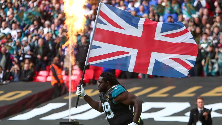 Marcell Dareus brings out the British flag before the International Series game between the Buffalo Bills and Jacksonville Jaguars at Wembley Stadium in London, England.