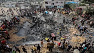 Palestinians inspect the rubble of a destroyed house following an Israeli airstrike on Khan Yunis in the southern Gaza Strip on Oct. 10, 2023