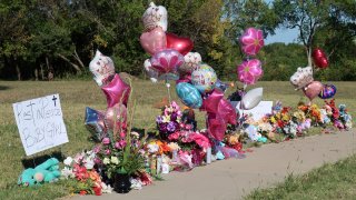 Zoey Felix, a 5-year-old girl, is honored with a makeshift memorial of flowers, balloons, signs and toys along a sidewalk, Thursday, Oct. 5, 2023, in Topeka, Kan.