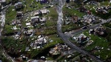 FILE - Destroyed communities are seen in the aftermath of Hurricane Maria in Toa Alta, Puerto Rico, Sept. 28, 2017. With warmer oceans serving as fuel, Atlantic hurricanes are now more than twice as likely as before to rapidly intensify from wimpy minor hurricanes to powerful and catastrophic, a study said Thursday, Oct. 19, 2023. (AP Photo/Gerald Herbert, File)