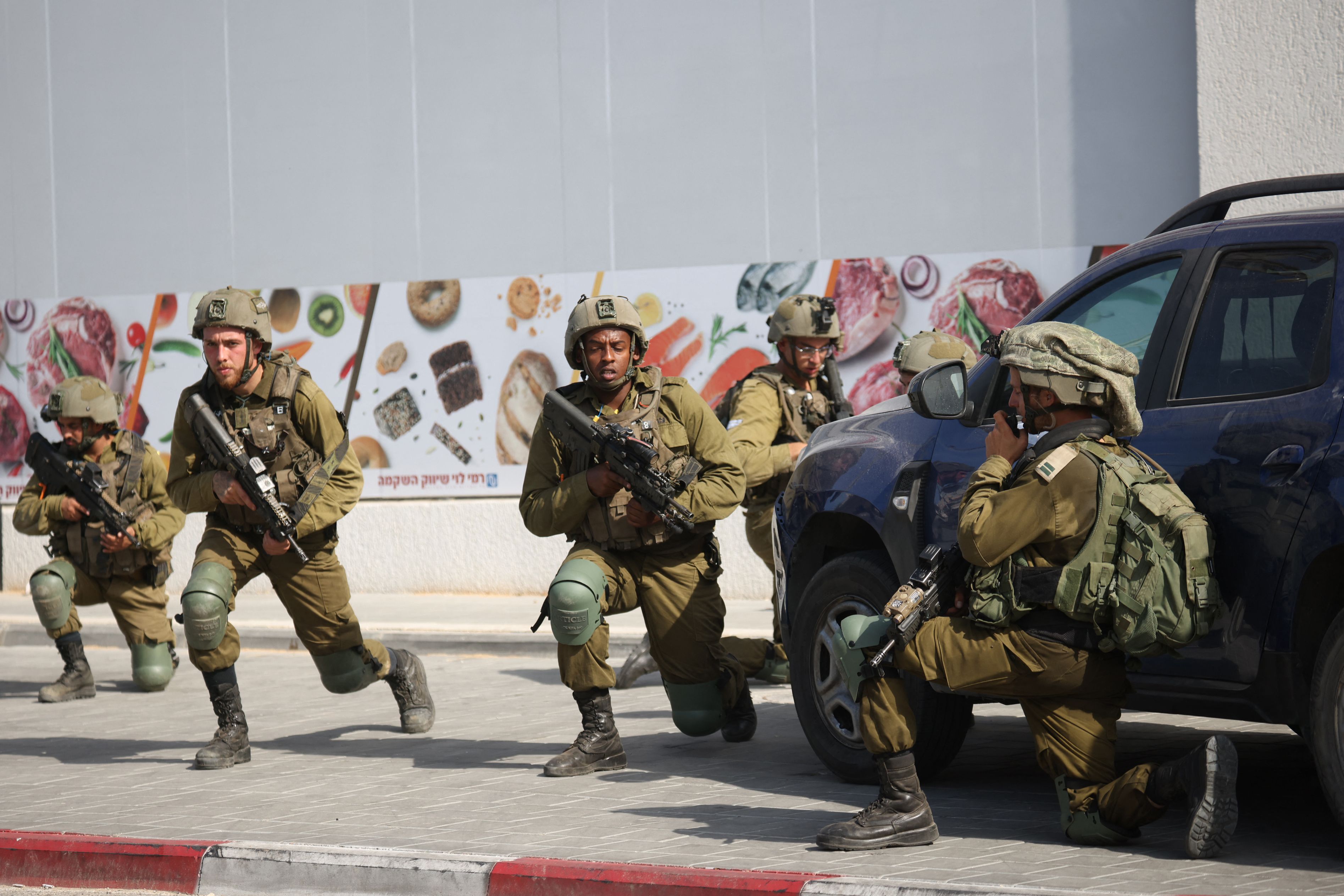 Israeli soldiers deploy in an area where civilians were killed in the southern city of Sderot on October 7, 2023.