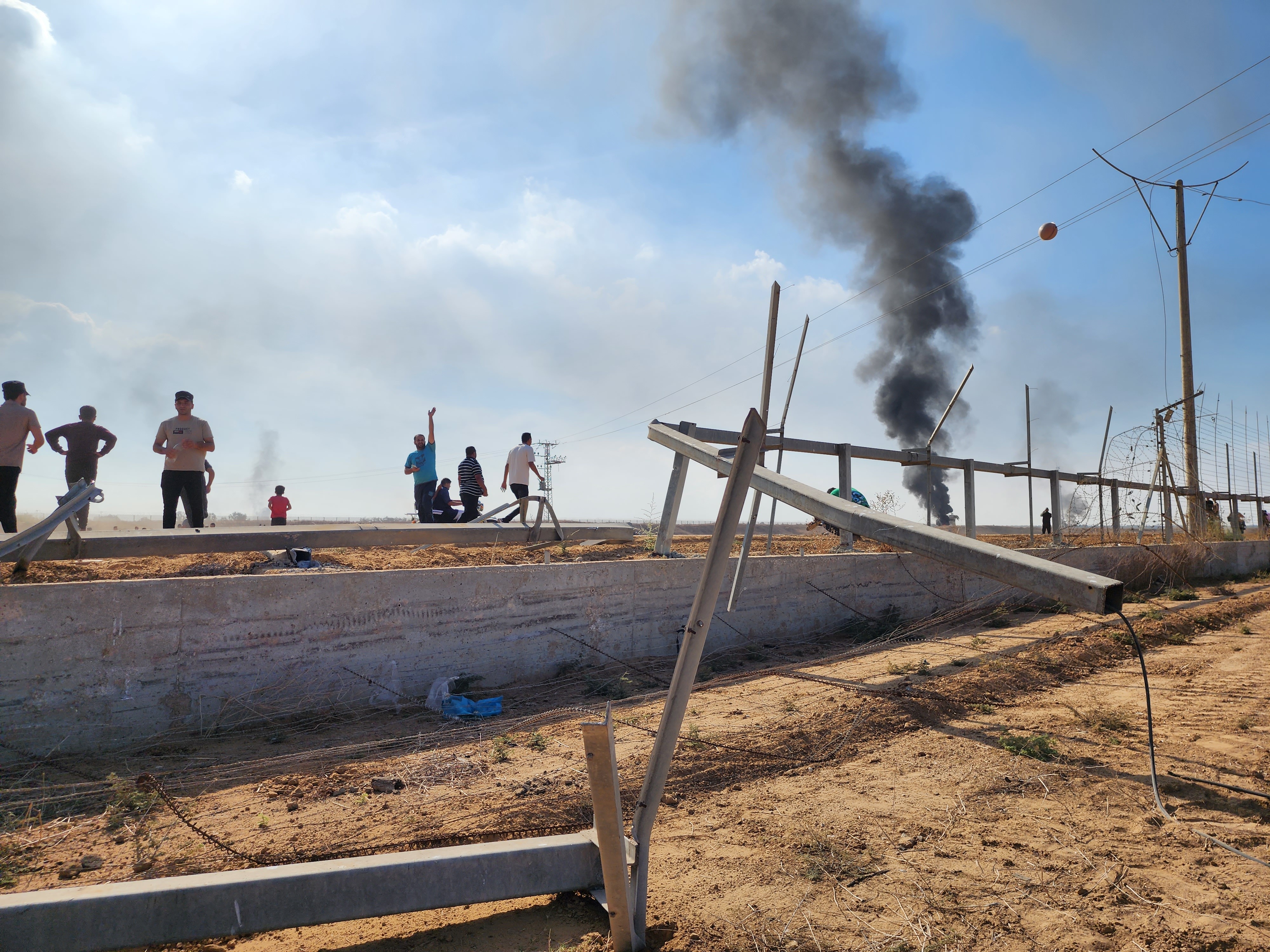 Palestinians take down the fence on the Israel-Gaza border and enter Israel on Oct. 7, 2023.