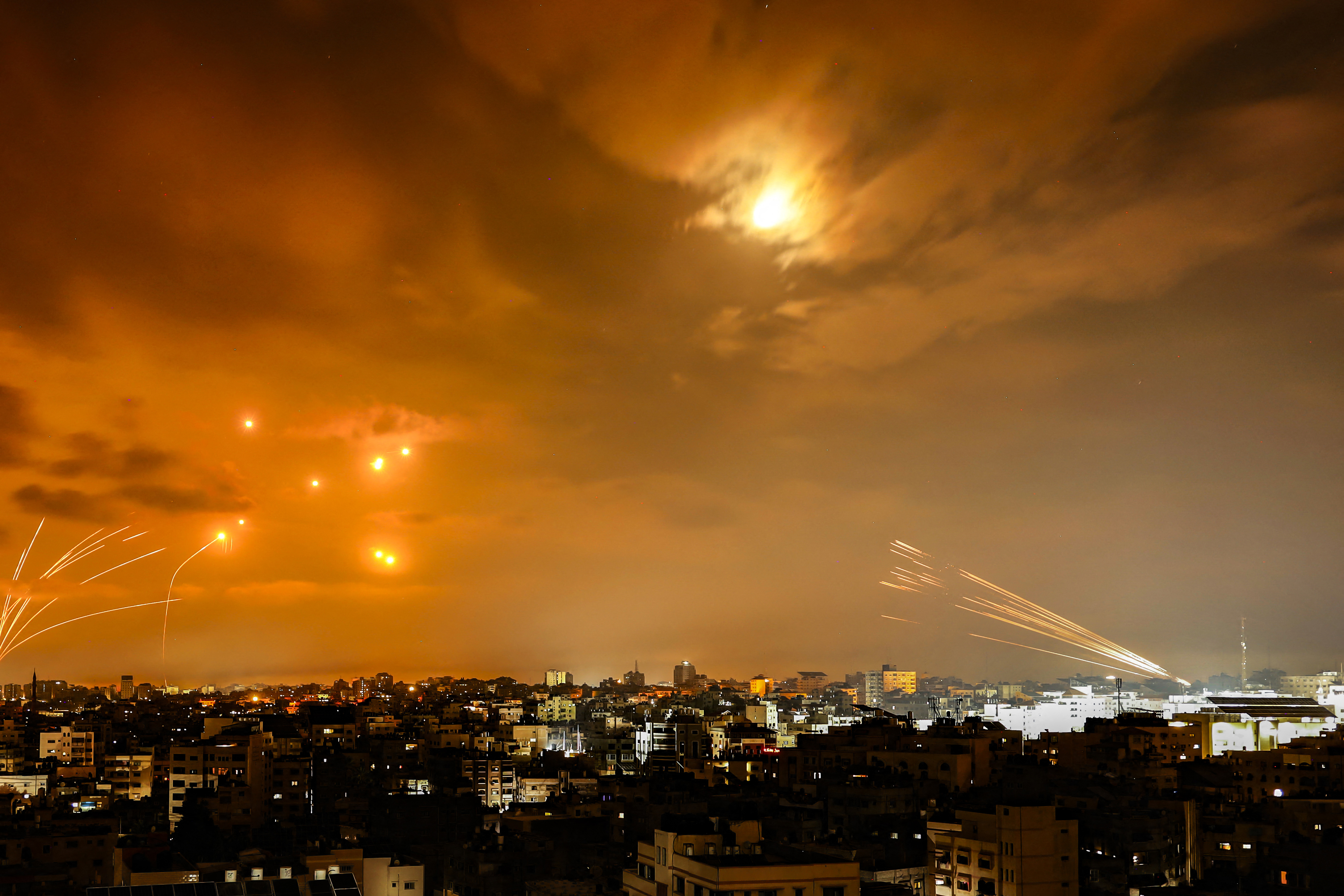 Rockets fired by Palestinian militants from Gaza City are intercepted by the Israeli Iron Dome defense missile system in the early hours of Oct. 8, 2023.