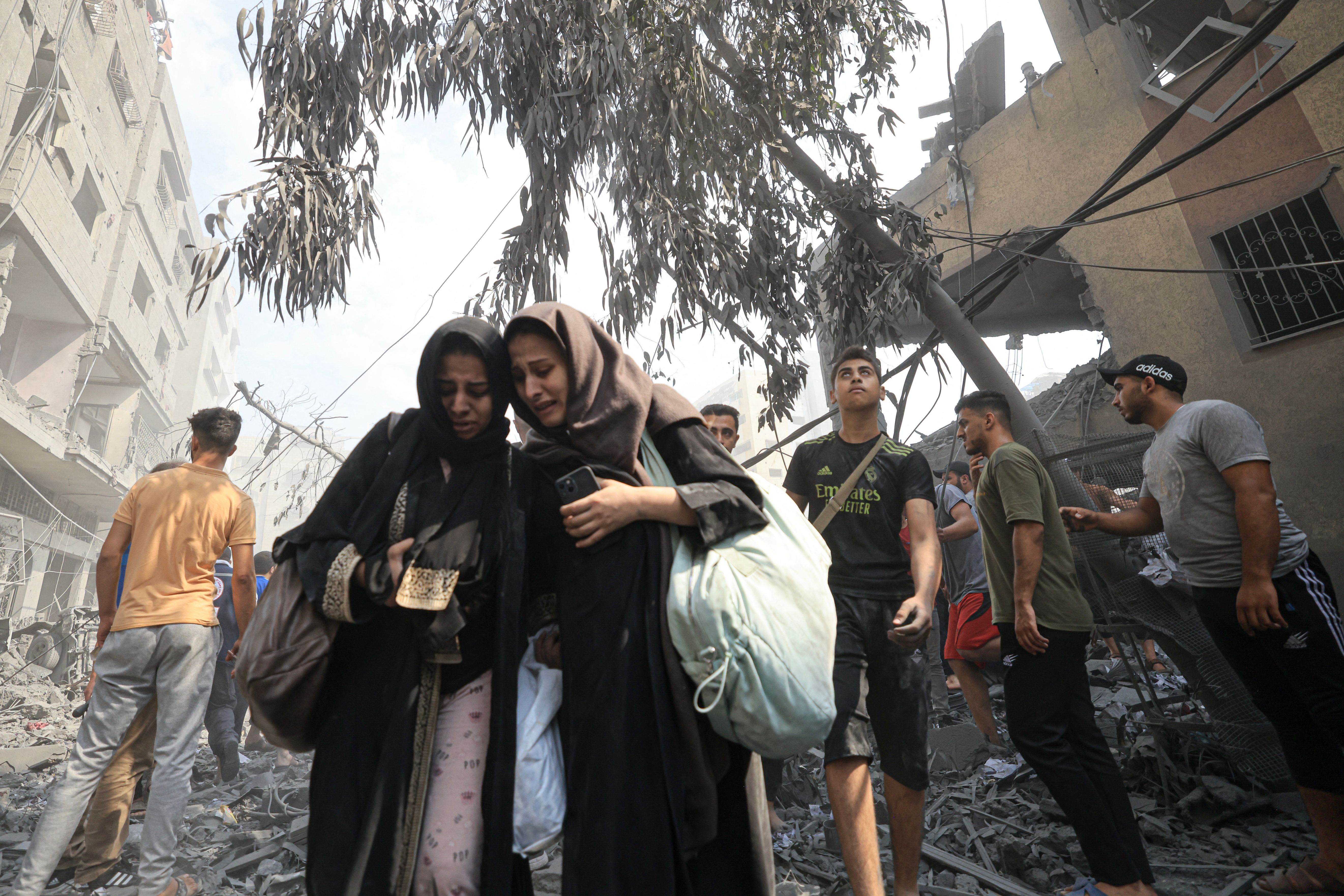 Palestinians evacuate the area following an Israeli airstrike on the Sousi mosque in Gaza City on Oct. 9, 2023.
