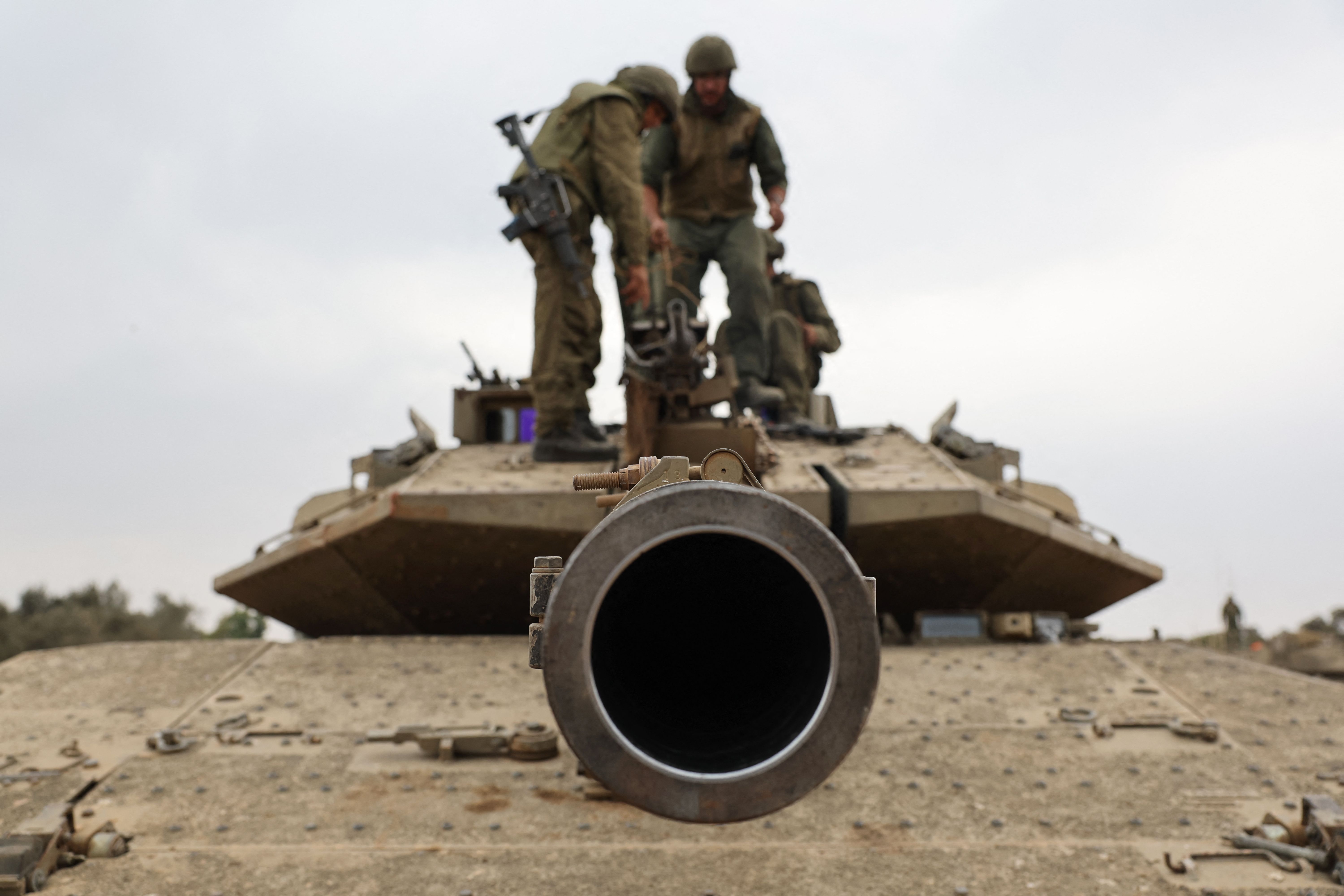 Israeli army soldiers are positioned with their Merkava tanks near the border with the Gaza Strip in southern Israel on Oct. 9, 2023.