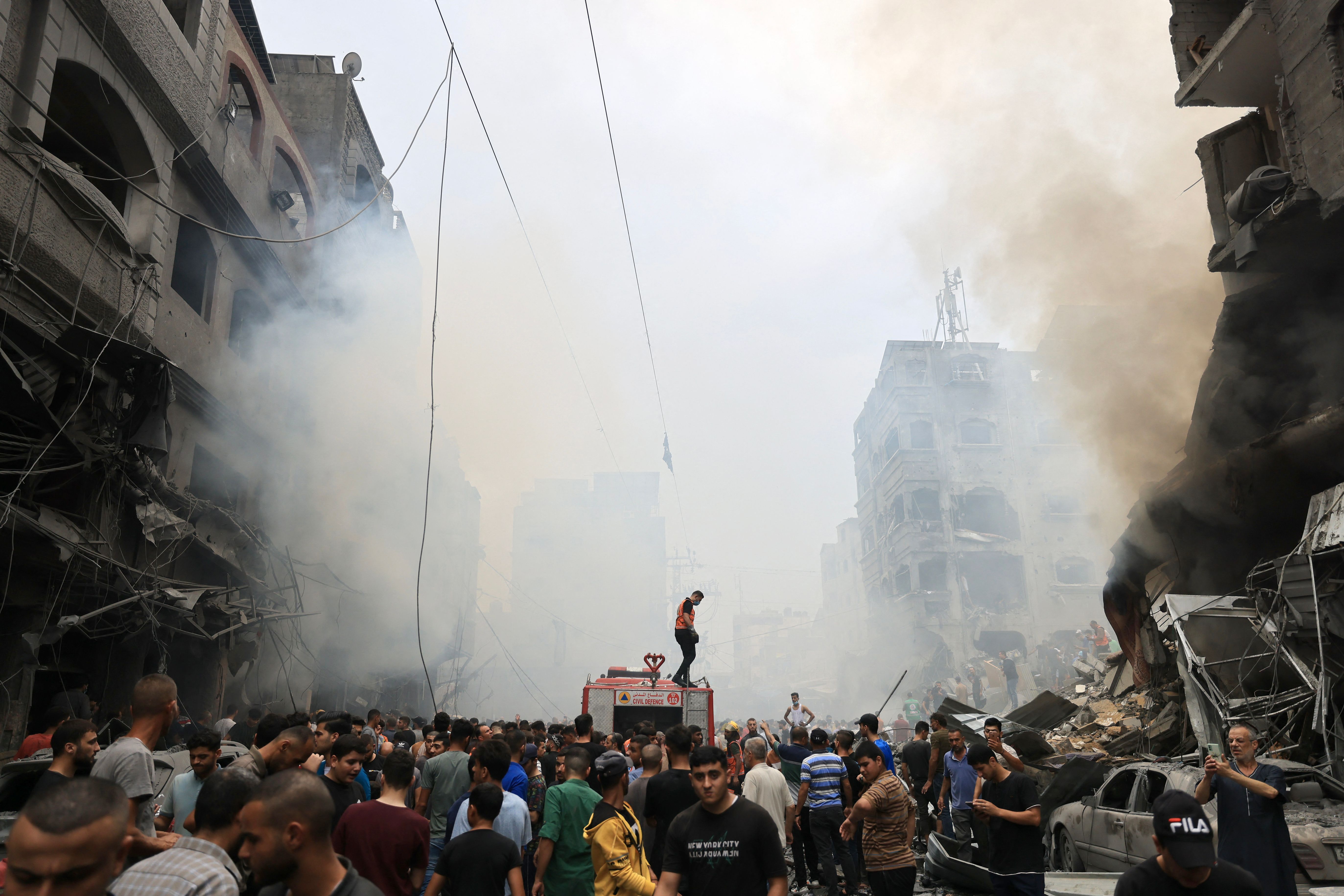 Palestinians search for survivors after an Israeli airstrike on buildings in the refugee camp of Jabalia in the Gaza Strip on Oct. 9, 2023.