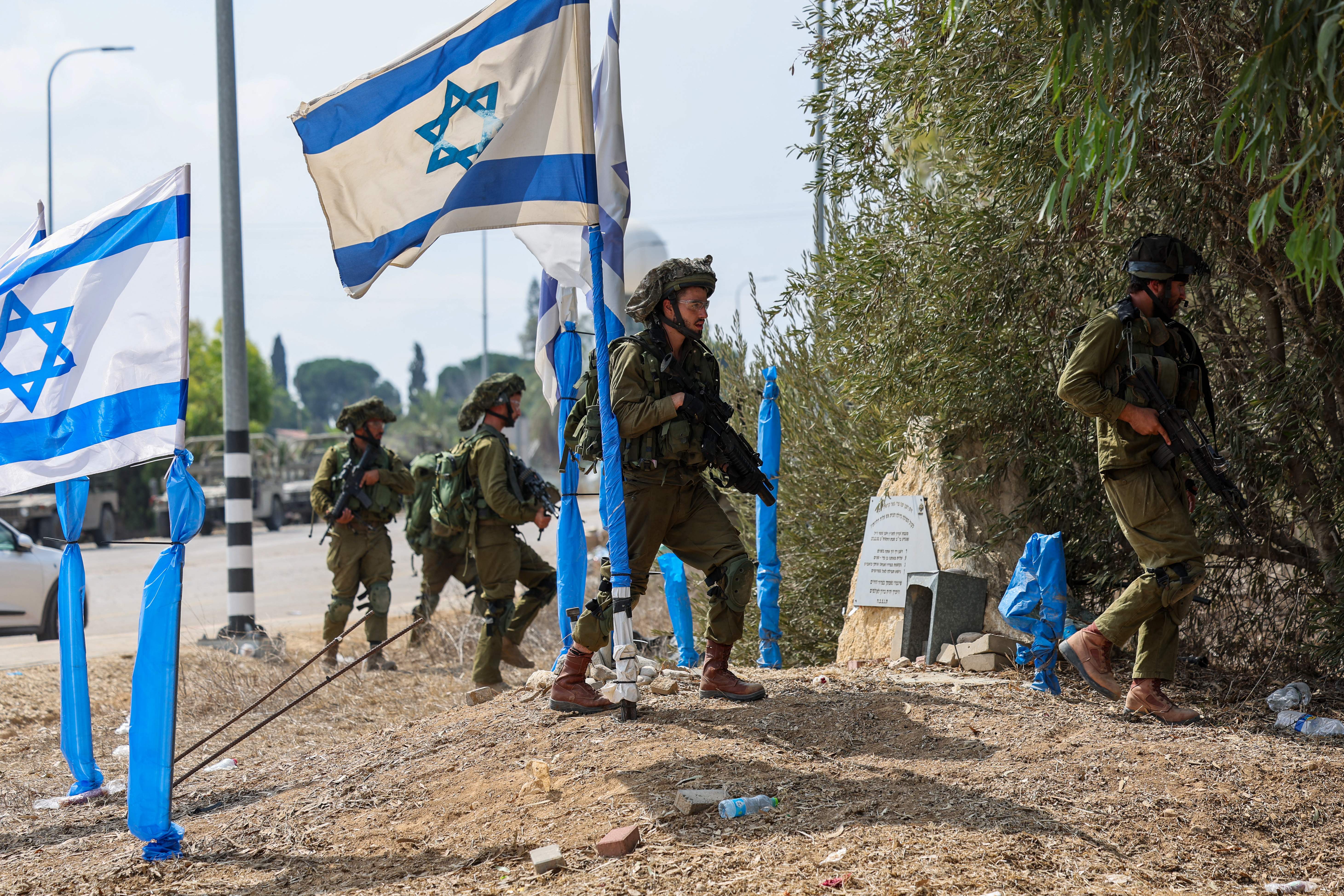 Israeli soldiers patrol an area in Kfar Aza, south of Israel bordering Gaza Strip, on Oct. 10, 2023.