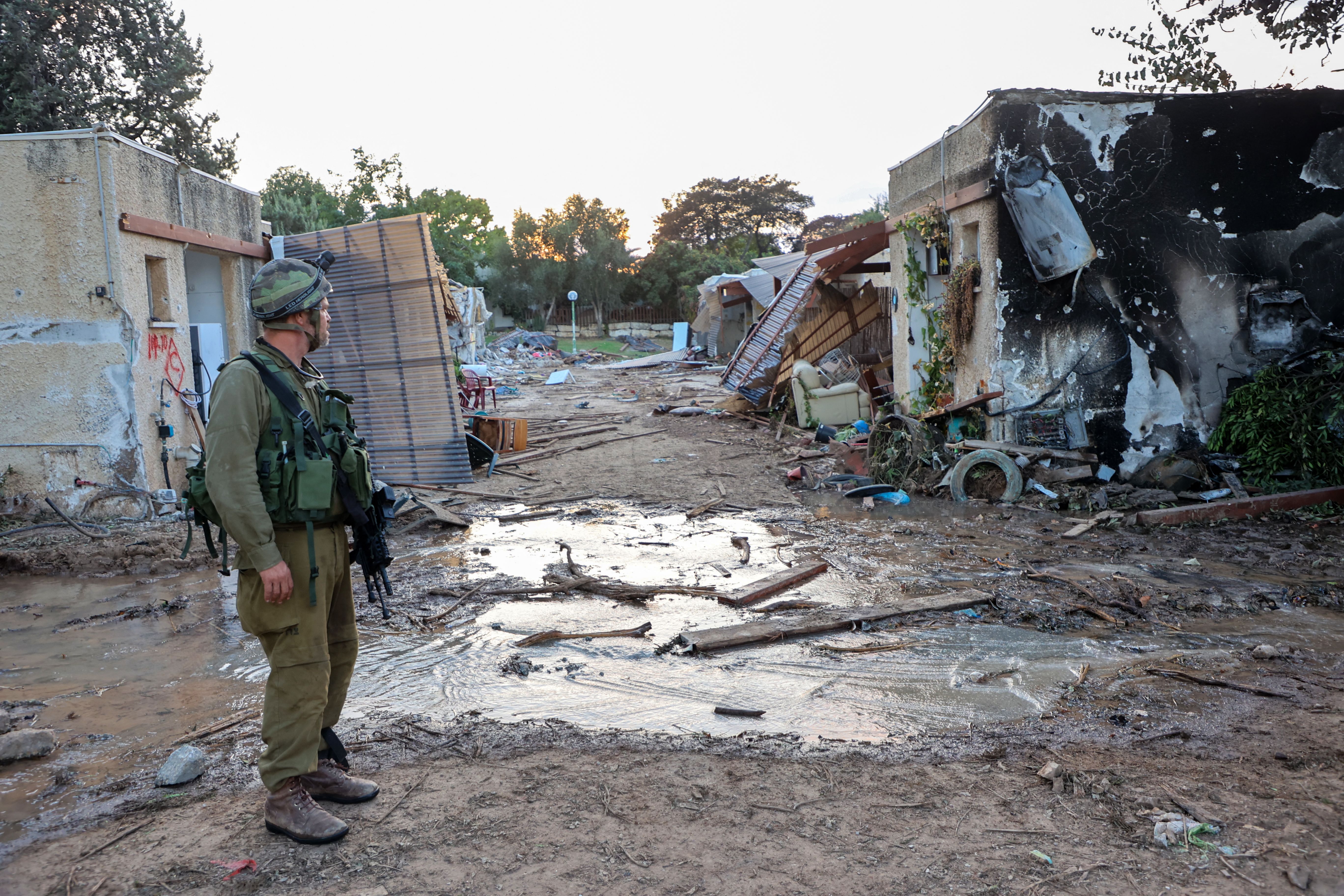 Israeli troops search the scene of a Palestinian militant attack in the Israeli kibbutz of Kfar Aza on the border with the Gaza Strip on Oct. 11, 2023.