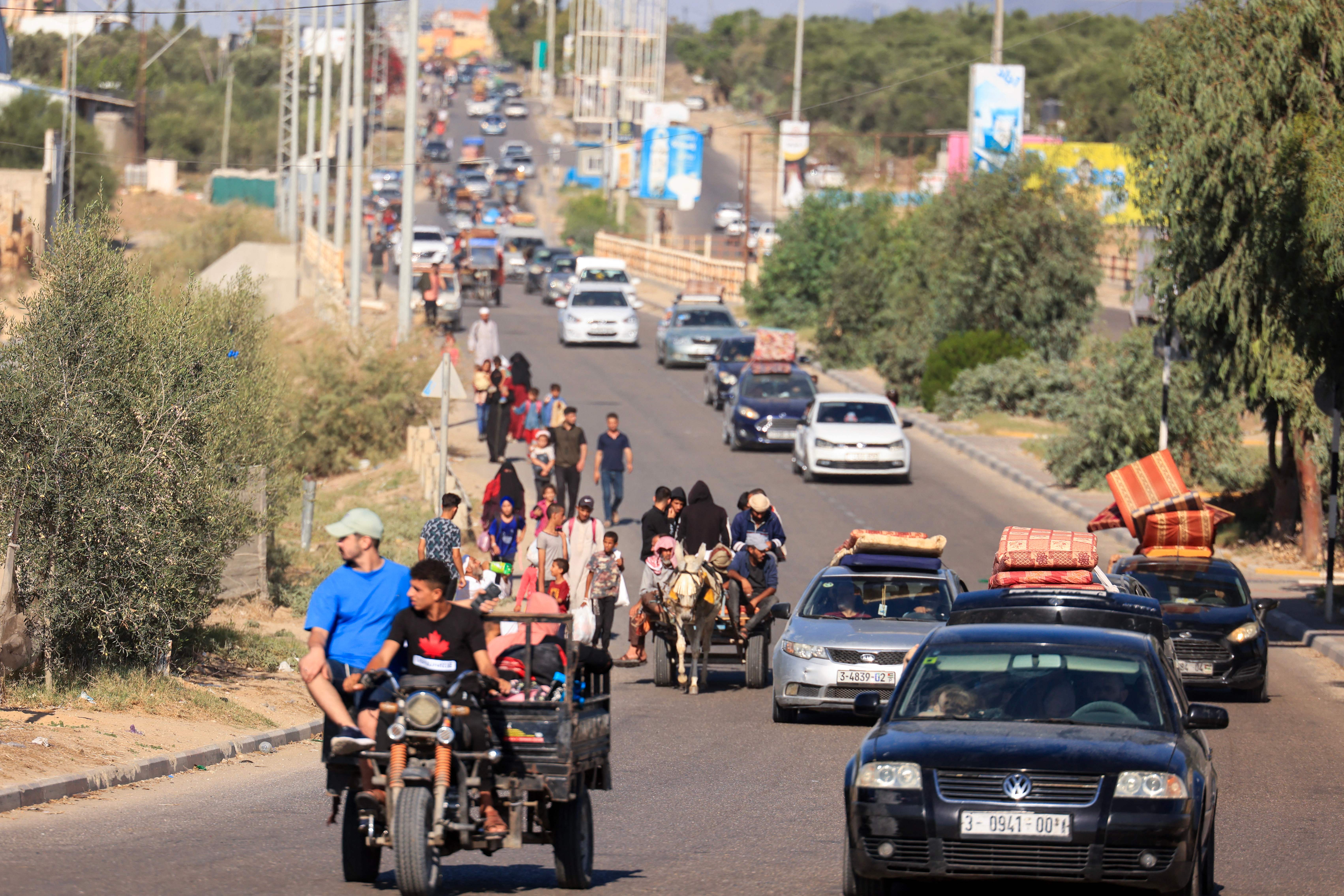 Palestinians with their belongings leave Gaza City as they flee from their homes following the Israeli army’s warning on Oct. 13, 2023.
