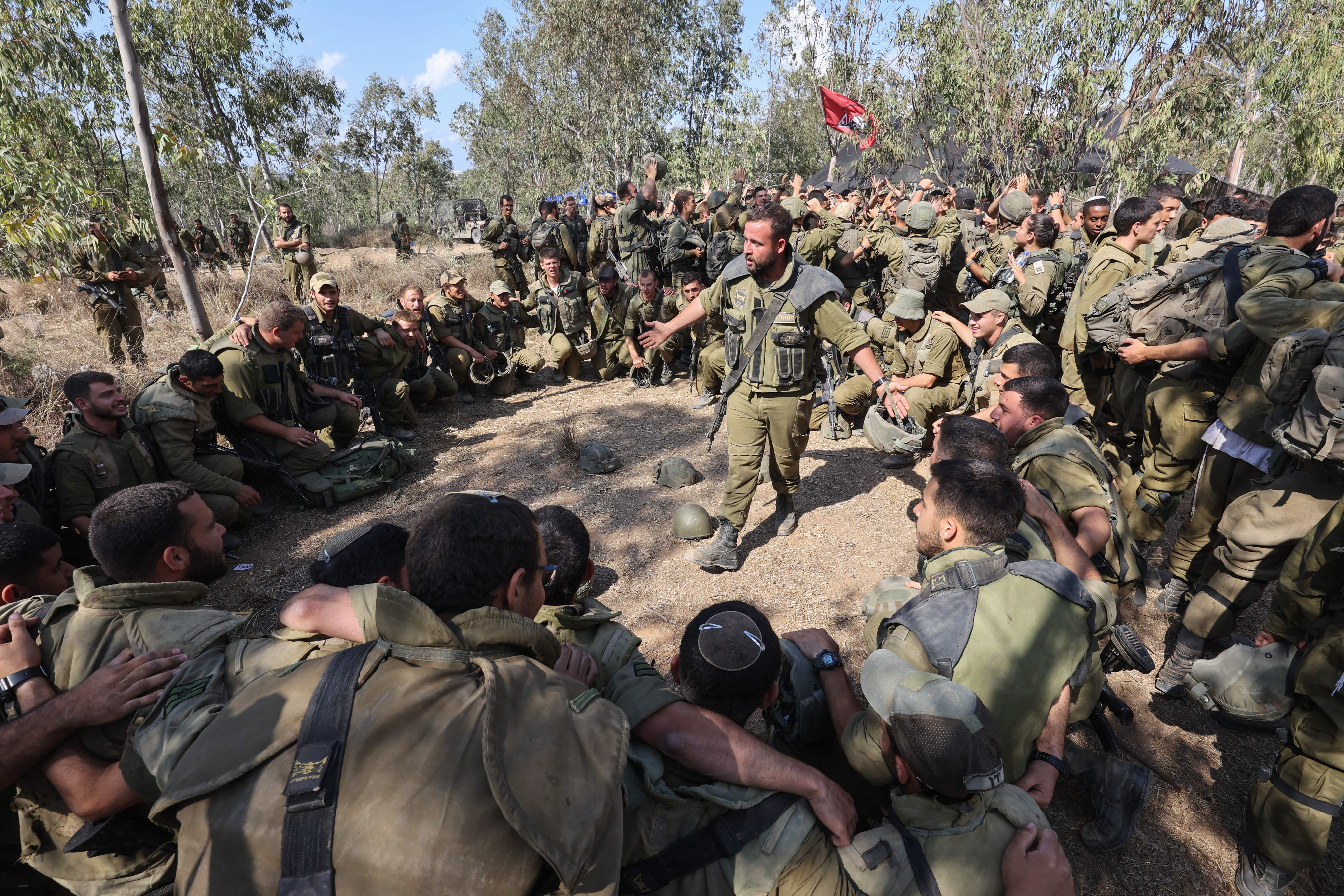 Israeli troops prepare weapons and armed vehicles near the southern city of Ashkelon on Oct. 15, 2023.