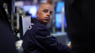 Traders work on the floor at the New York Stock Exchange (NYSE) in New York City, U.S., November 17, 2023.