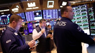 Traders work on the floor of the New York Stock Exchange during morning trading on December 01, 2023 in New York City.