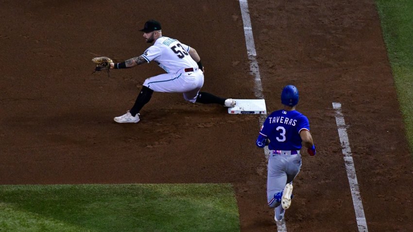 A runner runs along the baseline