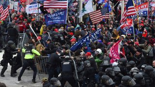 FILE - Trump supporters clash with police and security forces as they push barricades to storm the U.S. Capitol in Washington D.C on Jan. 6, 2021.