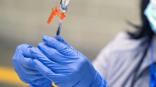 File - Los Angeles County Department of Public Health Nurse Eliane McGhee prepares a COVID-19 booster shot at the Los Angeles Convention Center Dec 2, 2022.