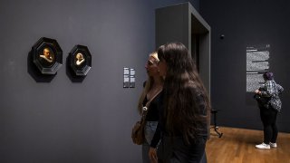 Visitors look at the two smallest portraits that Rembrandt ever painted at the Rijksmuseum in Amsterdam, on Dec. 13, 2023.