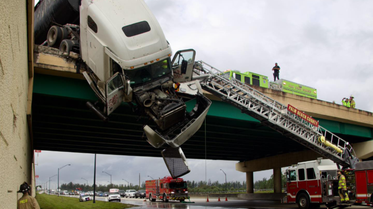 Tractortrailer dangles off highway overpass of Florida’s Turnpike