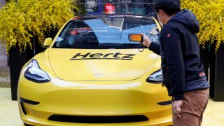A Hertz Tesla electric vehicle is displayed during the Hertz Corporation IPO at the Nasdaq Market site in Times Square in New York City, U.S., November 9, 2021.