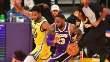 Lebron James (R) of the Los Angeles Lakers dribbles under pressure from Glen Robinson (L) of the Golden State Warriors during the regular season at the Staples Center in Los Angeles on November 13, 2019. (Photo by Frederic J. BROWN / AFP) (Photo by FREDERIC J. BROWN/AFP via Getty Images)