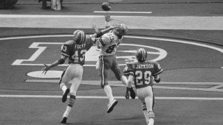 FILE – Despite the effort of Denver Broncos defensive back Steve Foley (43), Dallas Cowboys wide receiver Golden Richards hauls in a touchdown pass during NFL football’s Super Bowl 12 in New Orleans on Jan 15, 1978. Richards died Friday, Feb. 23, 2024, of congestive heart failure at his home in Murray, Utah. He was 73. Richards’ nephew Lance Richards confirmed his death in a post on his Facebook page. (AP Photo, File)