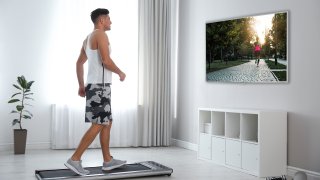 Sporty man training on walking treadmill